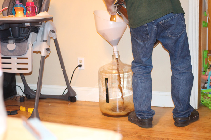 pouring wort into a carboy